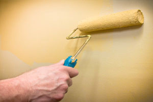 Handyman painting a wall