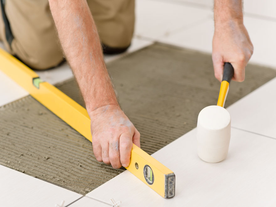 Handyman working on tile flooring
