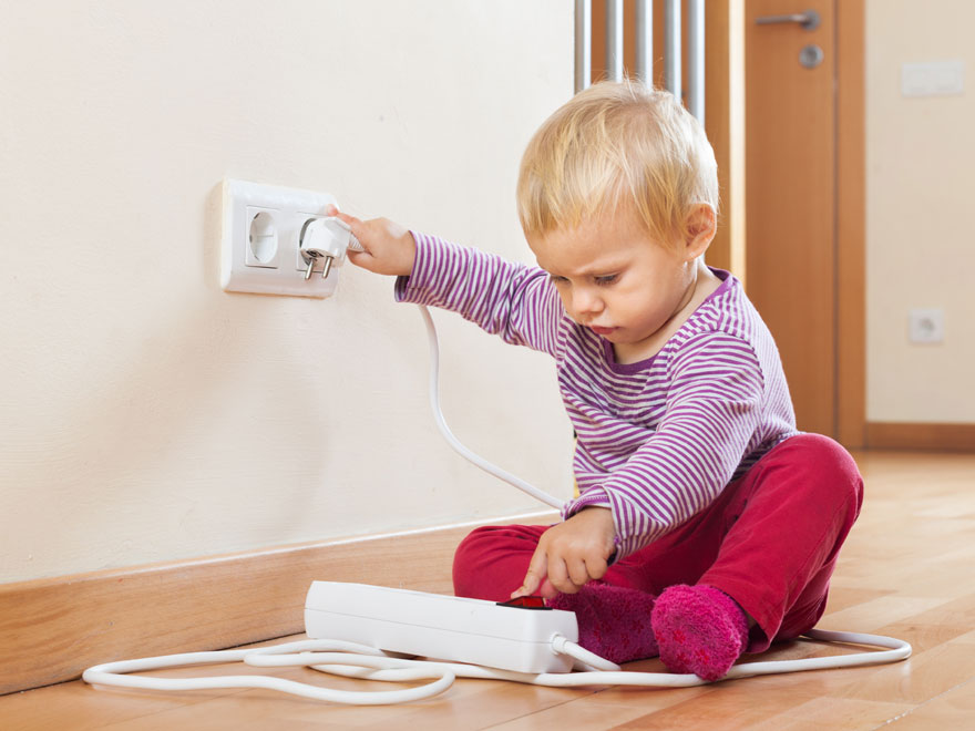 baby playing with electrical outlet